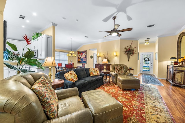 living room with crown molding, light hardwood / wood-style flooring, and ceiling fan with notable chandelier