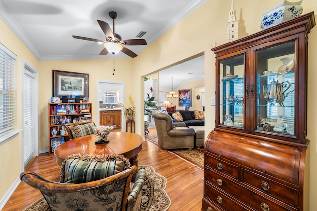 dining space with crown molding, plenty of natural light, ceiling fan, and light hardwood / wood-style floors