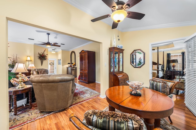 dining space featuring crown molding and wood-type flooring