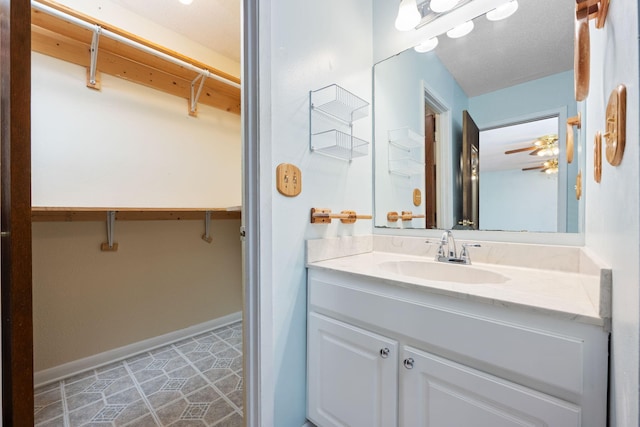 bathroom featuring tile patterned flooring, vanity, and ceiling fan