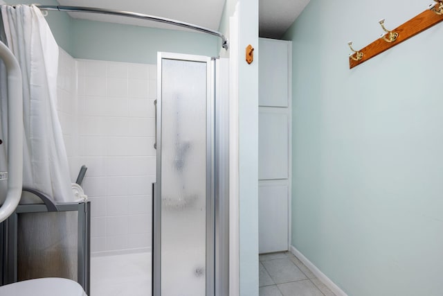 bathroom featuring tile patterned floors and an enclosed shower