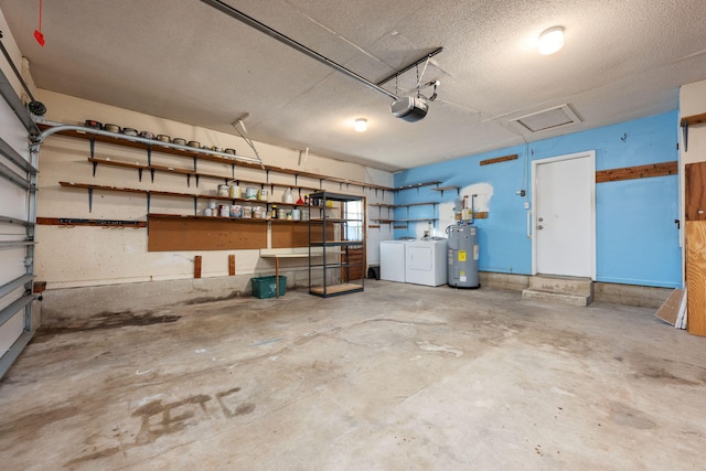 garage with water heater, a garage door opener, and independent washer and dryer