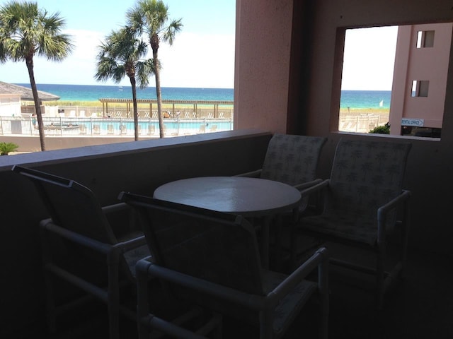 interior space featuring a water view and a beach view