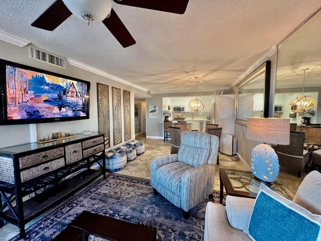 tiled cinema featuring sink, ceiling fan with notable chandelier, crown molding, and a textured ceiling