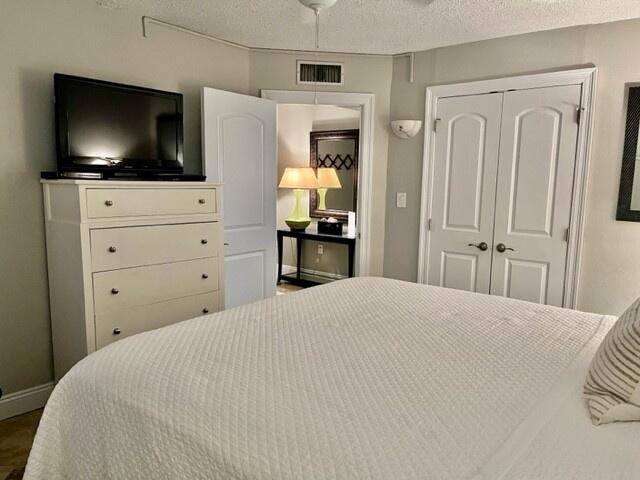 bedroom featuring a textured ceiling and a closet