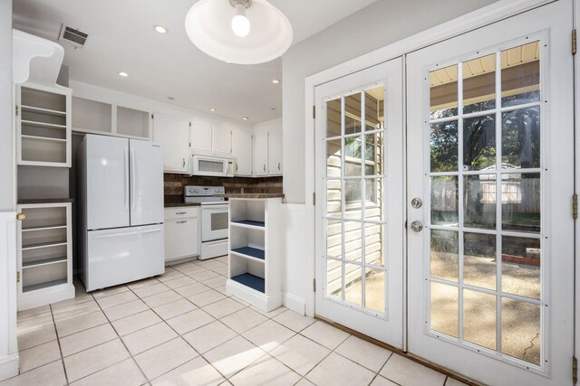 kitchen featuring white cabinets, white appliances, light tile patterned floors, and french doors