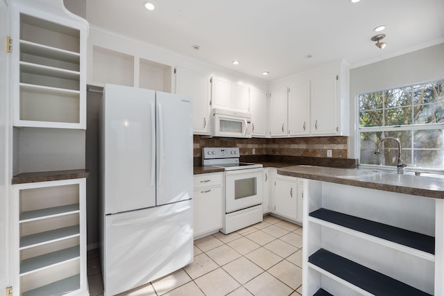 kitchen featuring white cabinetry, backsplash, white appliances, light tile patterned floors, and ornamental molding