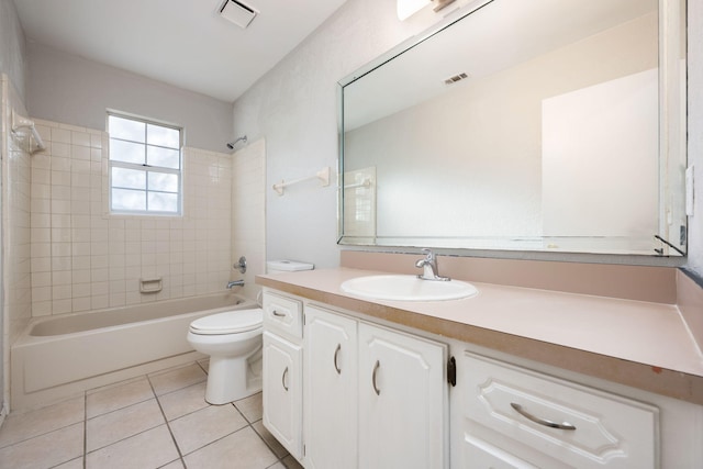 full bathroom with tile patterned flooring, vanity, toilet, and tiled shower / bath combo