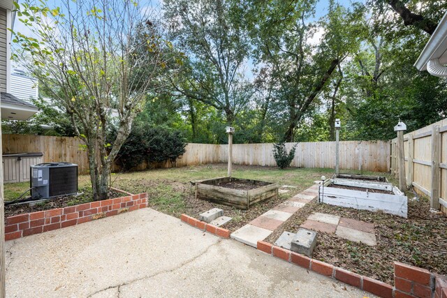 view of yard featuring cooling unit and a patio