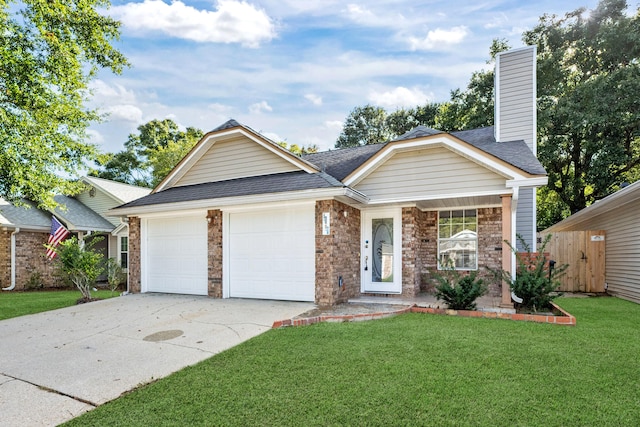 view of front of property with a front yard and a garage