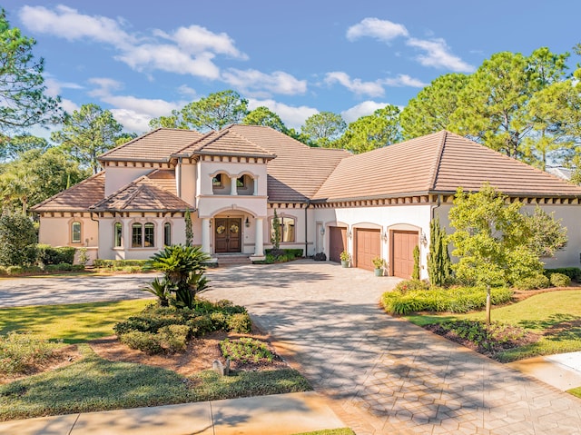 mediterranean / spanish-style house with a garage