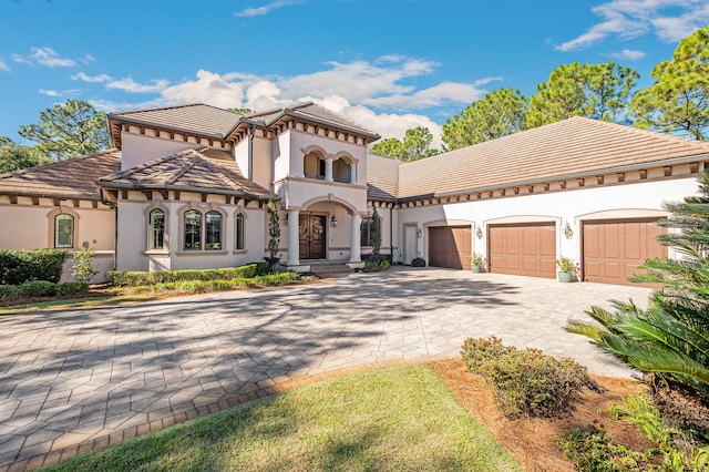 mediterranean / spanish home featuring a garage