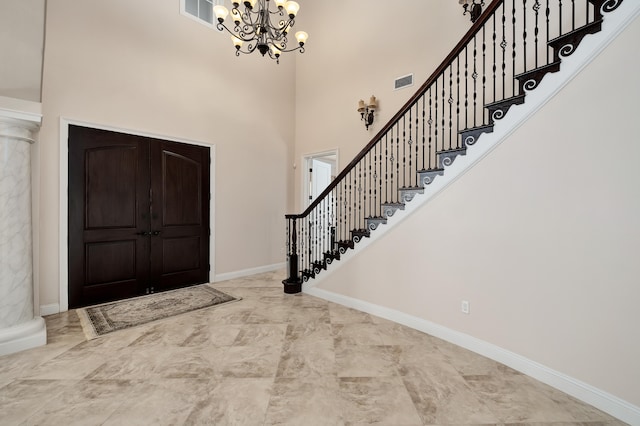 entryway featuring a high ceiling and an inviting chandelier