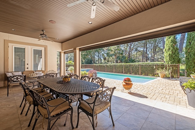 view of patio with french doors, a fenced in pool, and ceiling fan