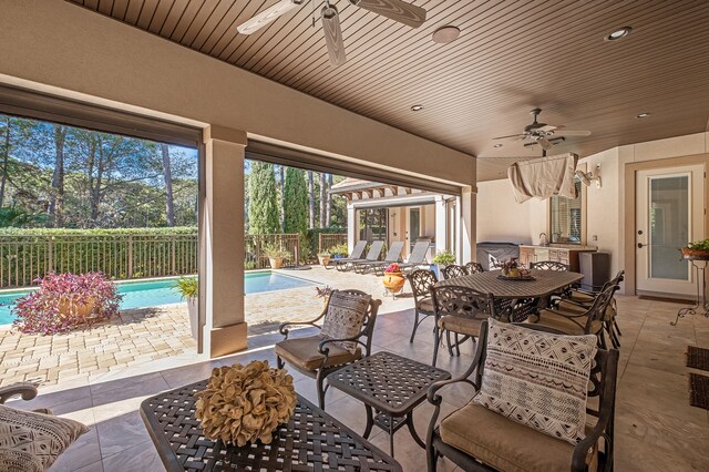 view of patio with a fenced in pool and ceiling fan