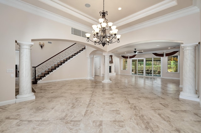 unfurnished living room featuring ceiling fan with notable chandelier, ornate columns, crown molding, and a tray ceiling