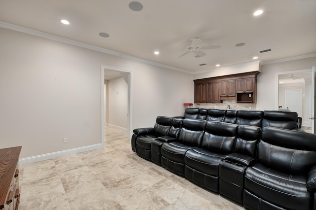 home theater room featuring ceiling fan and ornamental molding