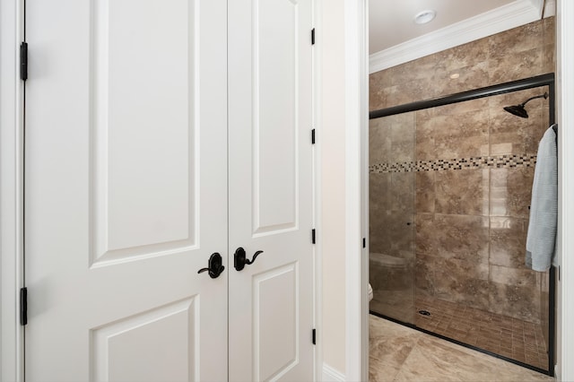 bathroom with crown molding, toilet, and walk in shower