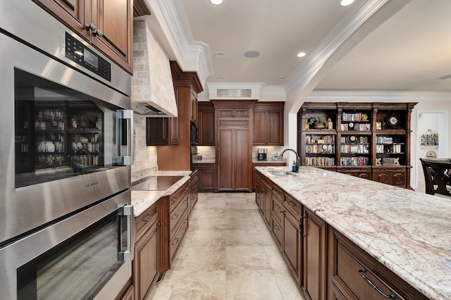 kitchen featuring black appliances, light stone counters, crown molding, and sink