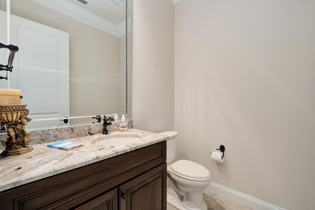 bathroom featuring tile patterned floors, vanity, toilet, and ornamental molding