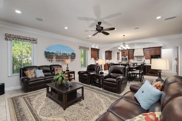 living room featuring ceiling fan with notable chandelier, plenty of natural light, and crown molding