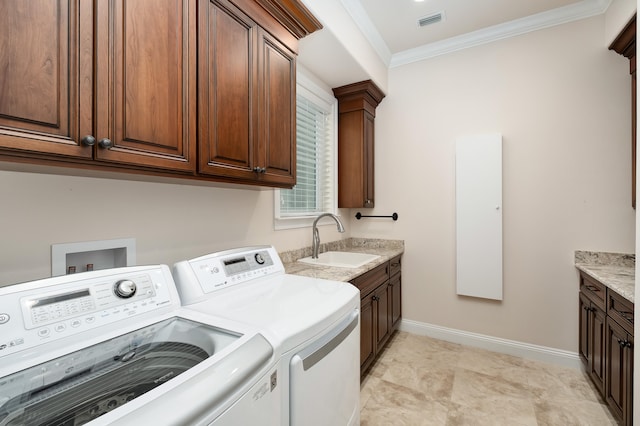 laundry area with cabinets, independent washer and dryer, ornamental molding, and sink