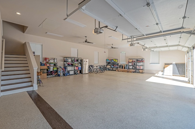 garage featuring ceiling fan, stainless steel refrigerator, and a garage door opener