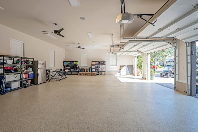 garage with a garage door opener, stainless steel refrigerator, and ceiling fan