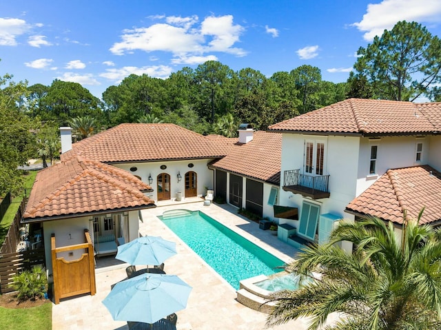 view of pool with an in ground hot tub and a patio area