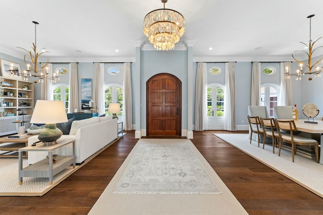 entrance foyer with dark hardwood / wood-style flooring, plenty of natural light, and crown molding