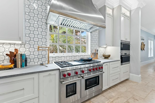 kitchen featuring white cabinetry, tasteful backsplash, crown molding, island range hood, and appliances with stainless steel finishes