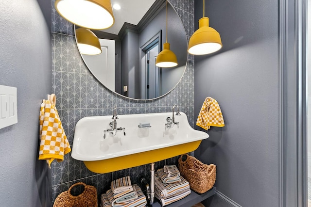 bathroom with sink, tile walls, and ornamental molding