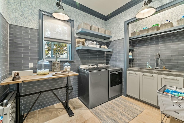 kitchen with backsplash, sink, washer and dryer, and ornamental molding