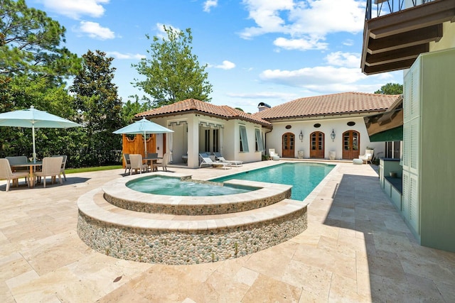 view of pool featuring an in ground hot tub and a patio area