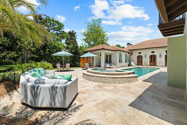 view of swimming pool featuring an in ground hot tub, outdoor lounge area, and a patio