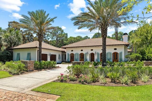 mediterranean / spanish home with a garage