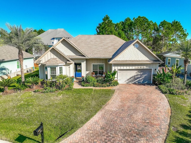 view of front of property featuring a front yard and a garage