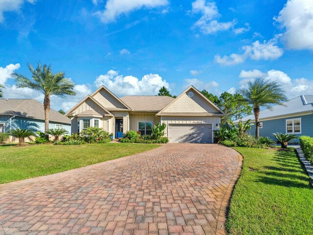 view of front of house featuring a front yard and a garage