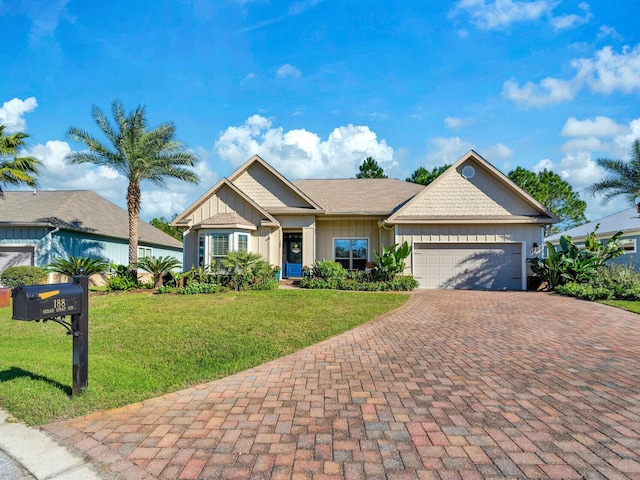 view of front of house featuring a front yard and a garage