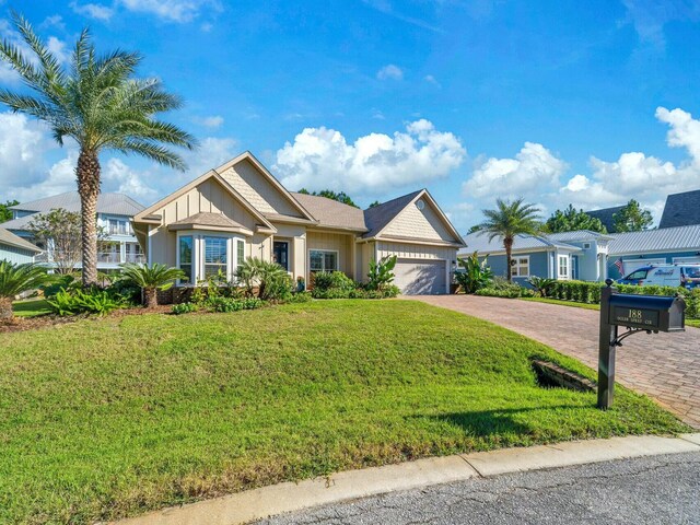 view of front of house with a front yard and a garage