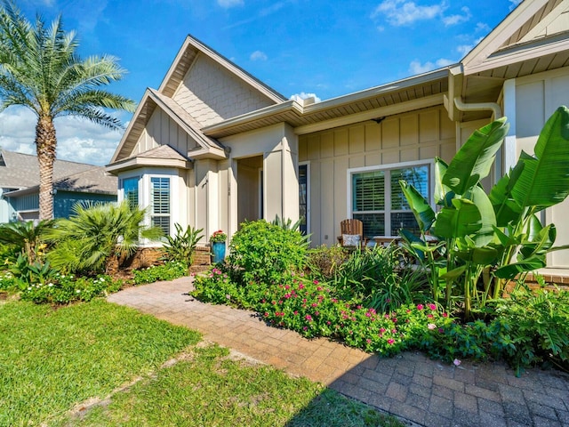 entrance to property with a lawn