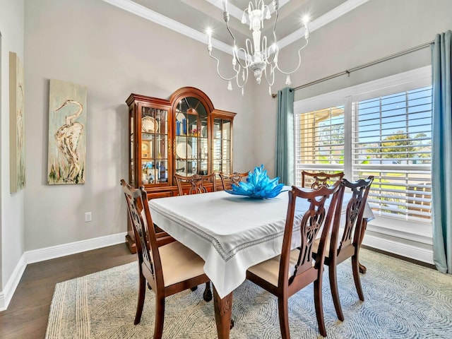 dining room with a towering ceiling, an inviting chandelier, crown molding, and wood-type flooring