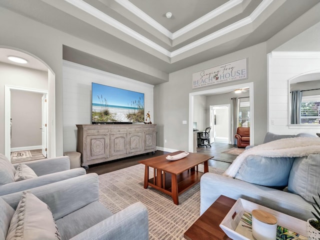 living room with a tray ceiling and crown molding