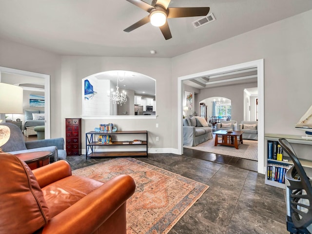 living room with ceiling fan with notable chandelier