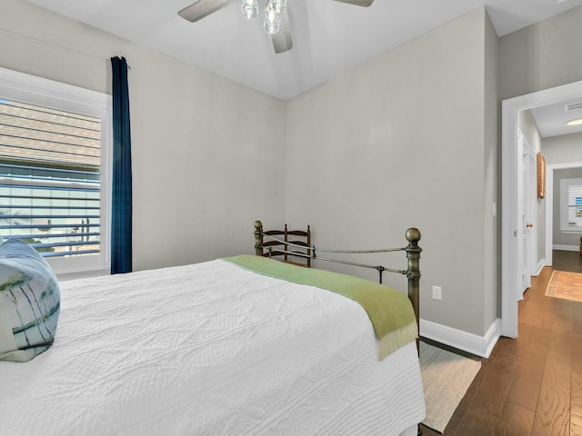 bedroom with dark wood-type flooring and ceiling fan