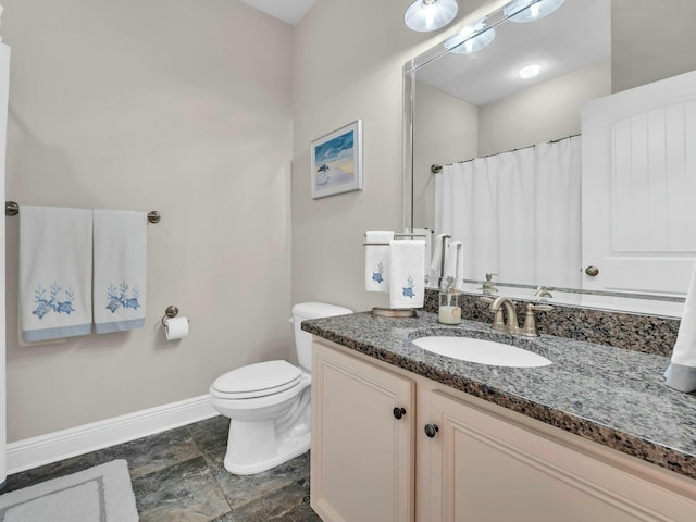 bathroom with toilet and vanity