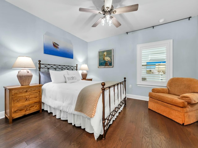 bedroom with ceiling fan and dark wood-type flooring