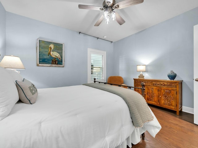 bedroom with ceiling fan and hardwood / wood-style flooring