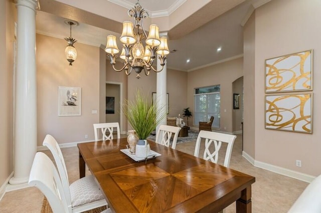 dining area featuring decorative columns, arched walkways, baseboards, and crown molding