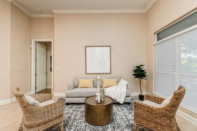 sitting room featuring tile patterned flooring, crown molding, and baseboards